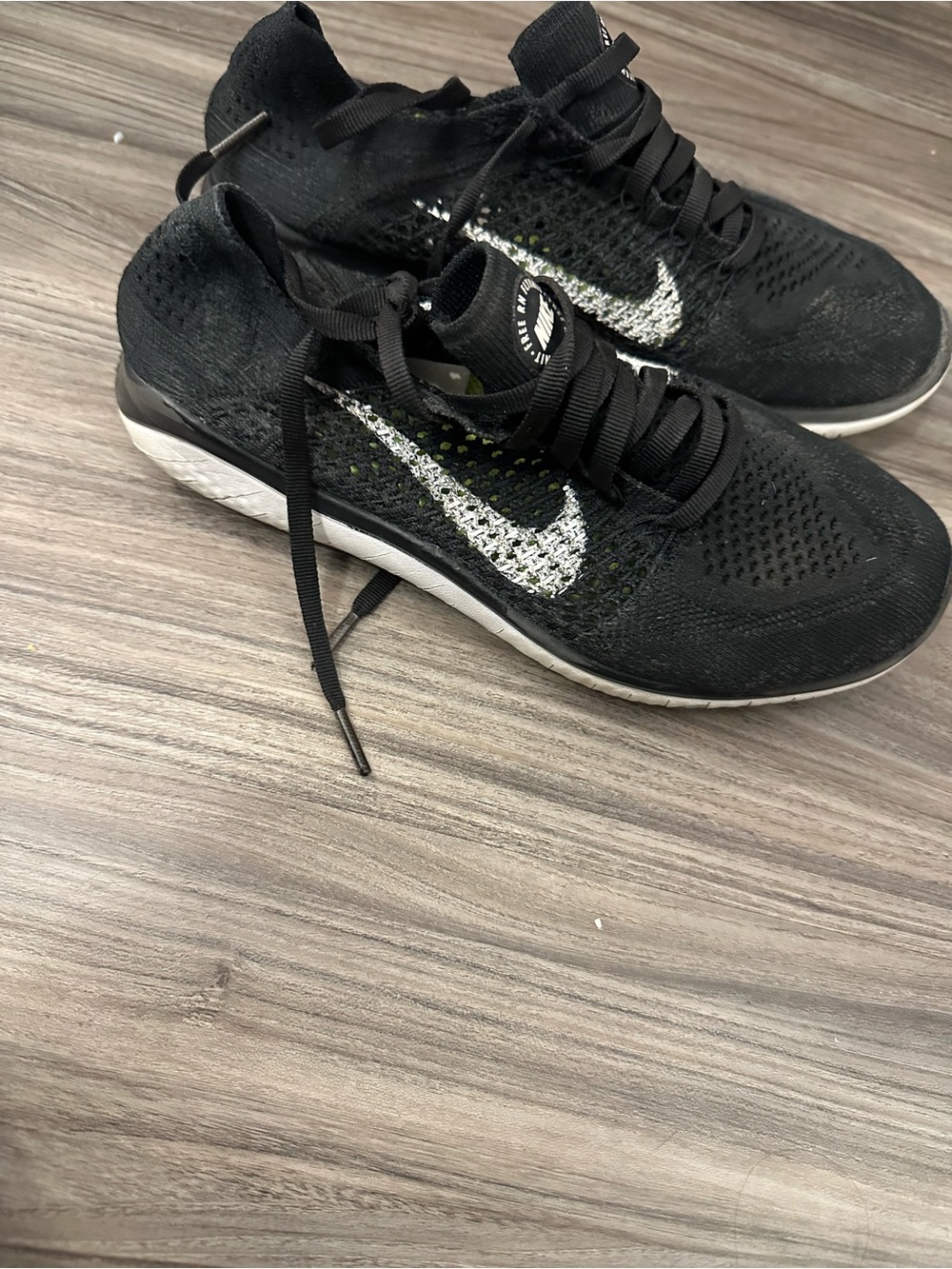 Nike Women’s Black Flyknit Sneakers with White Swoosh